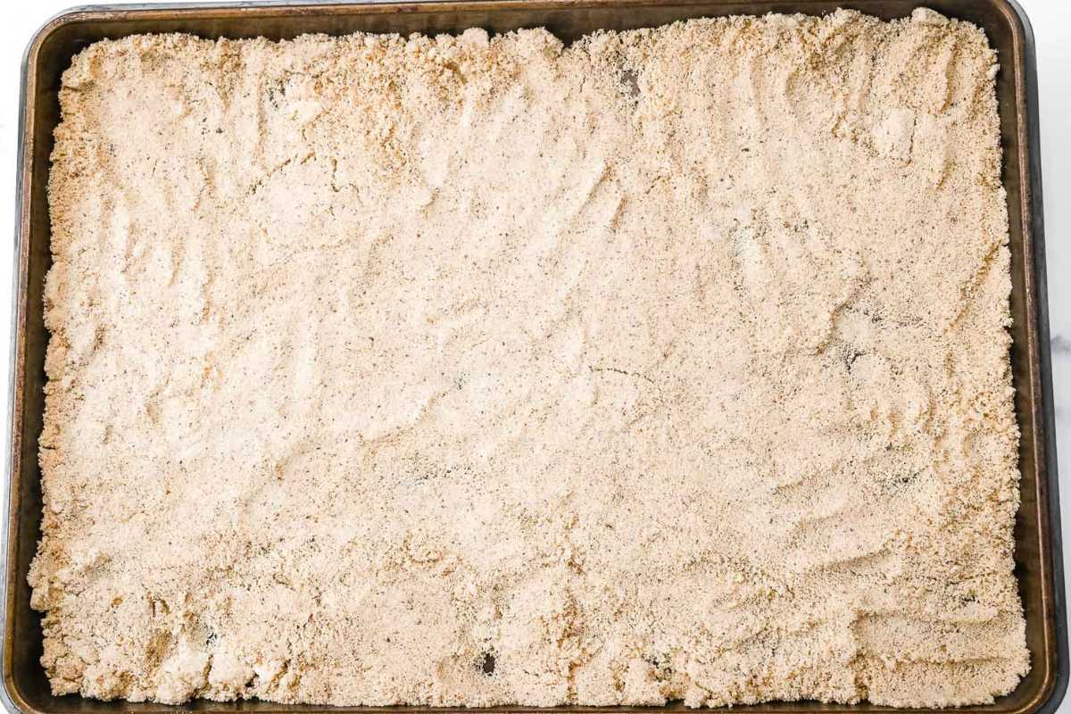 almond flour and pecans crust on a sheet pan to be toasted.