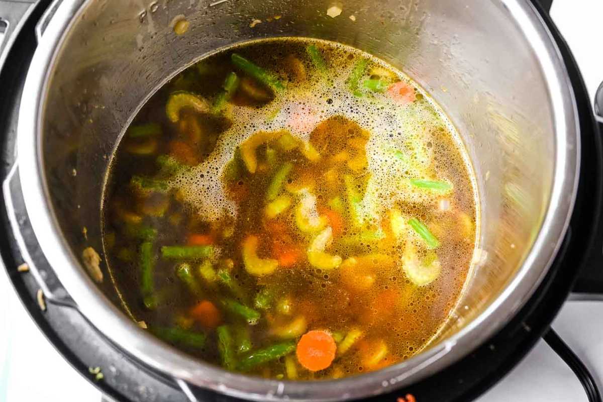 vegetables and broth in an instant pot.