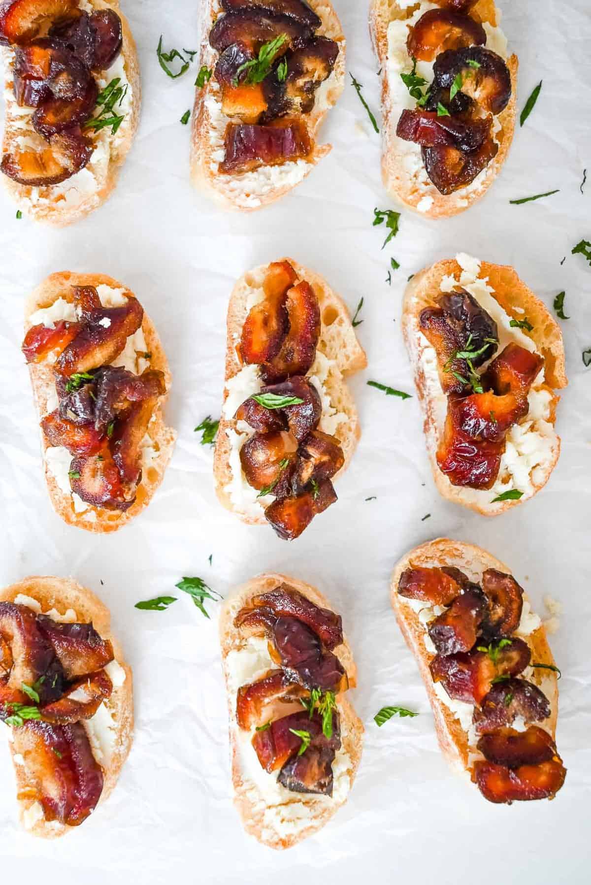 goat cheese crostini topped with mint on a white background.