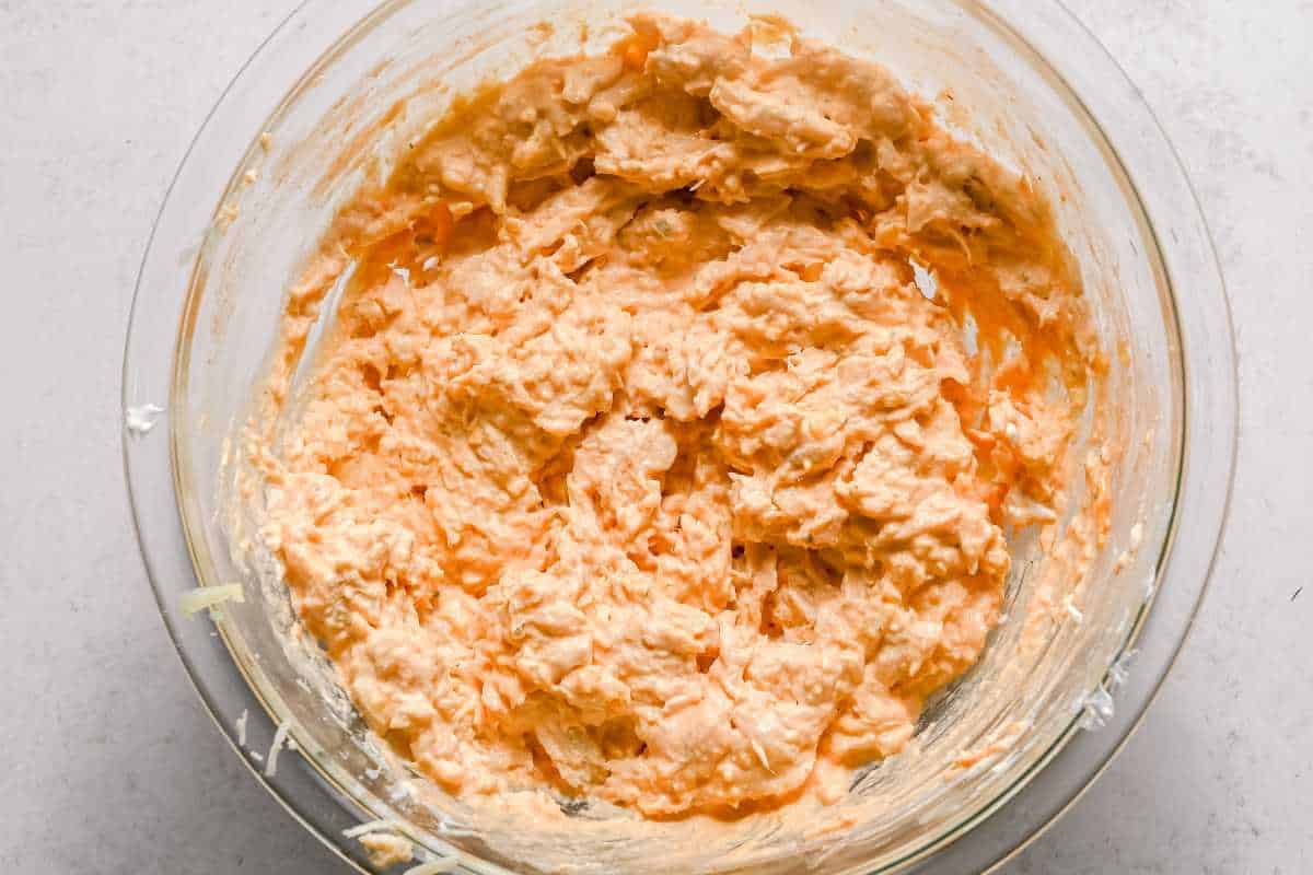 mixed buffalo chicken dip in a glass bowl.
