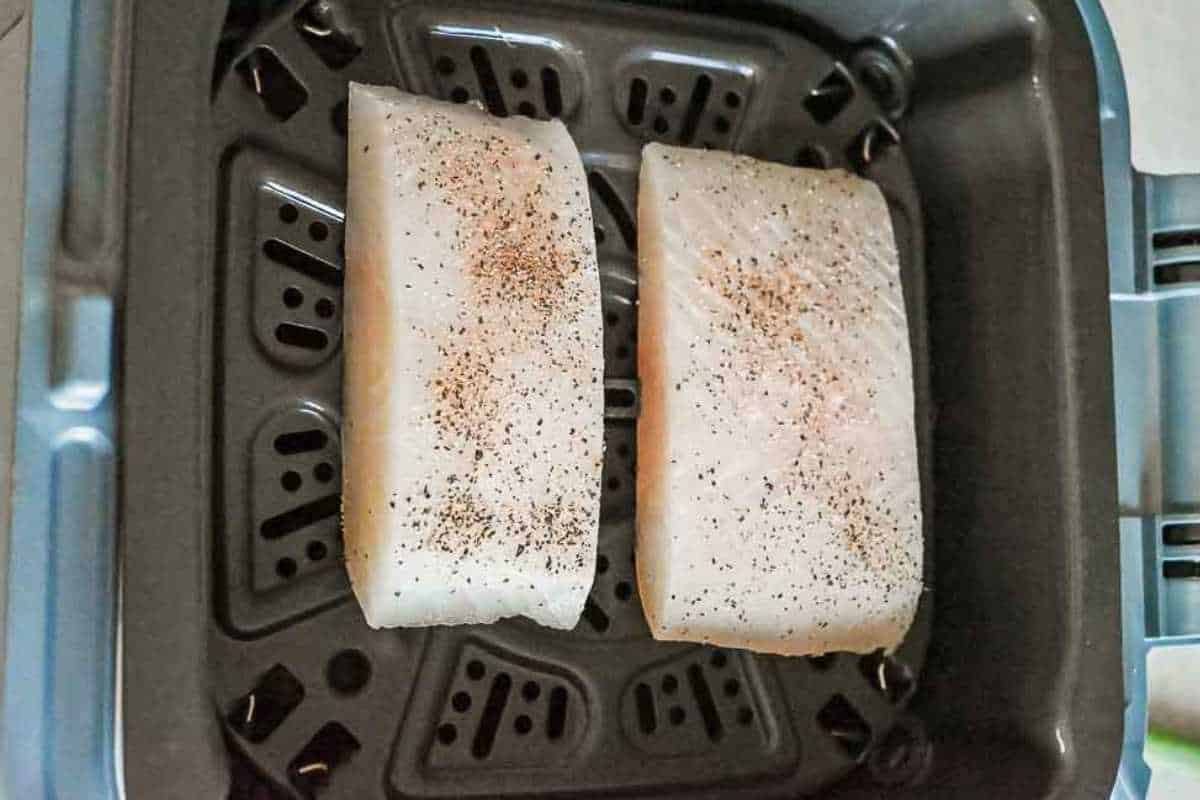 air fryer halibut in cooking basket.