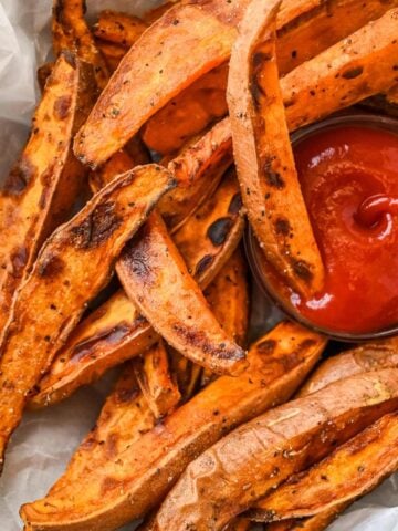 close up shot of air fryer sweet potato wedges with ketchup.