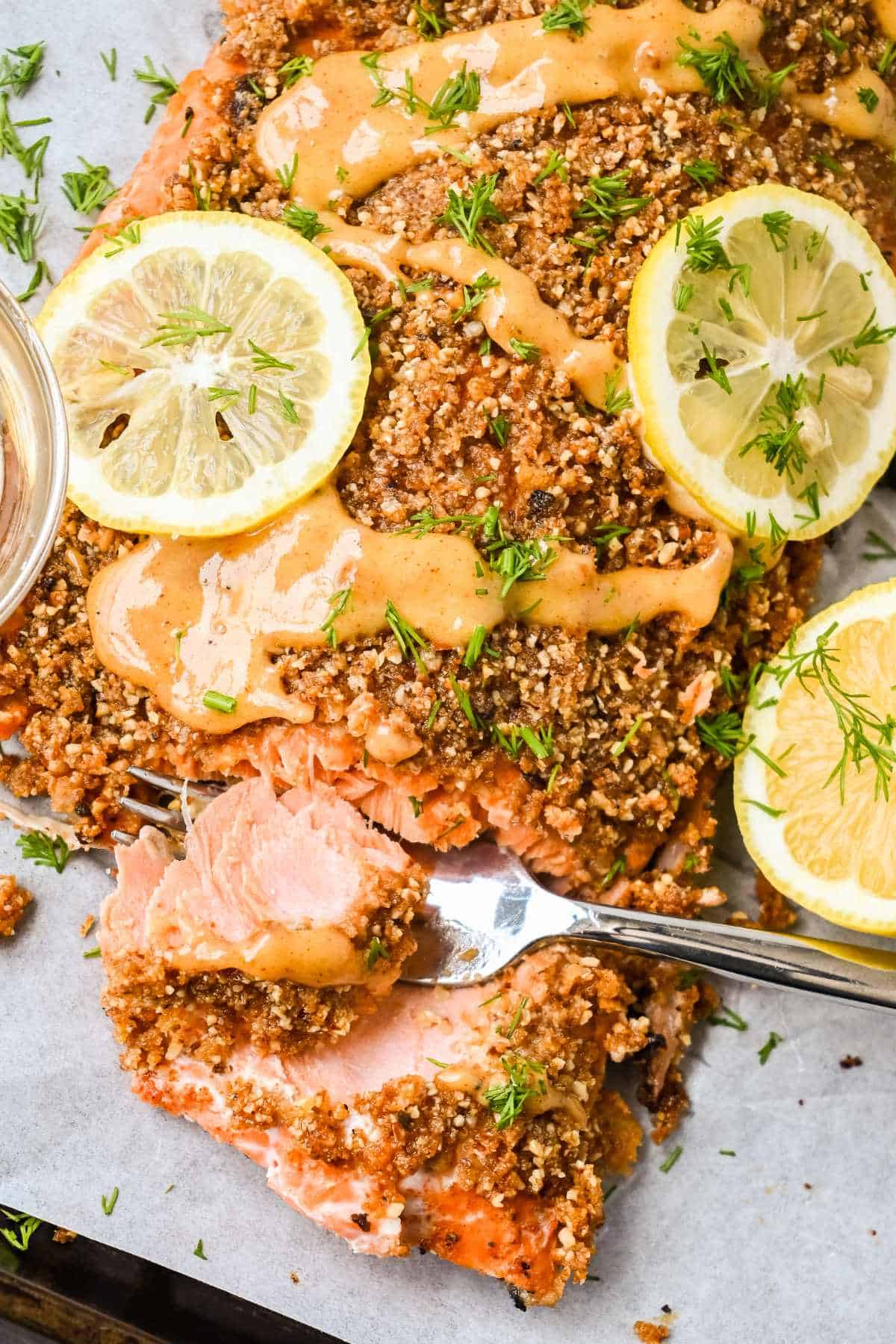 close up shot of fish flaking off of fork.