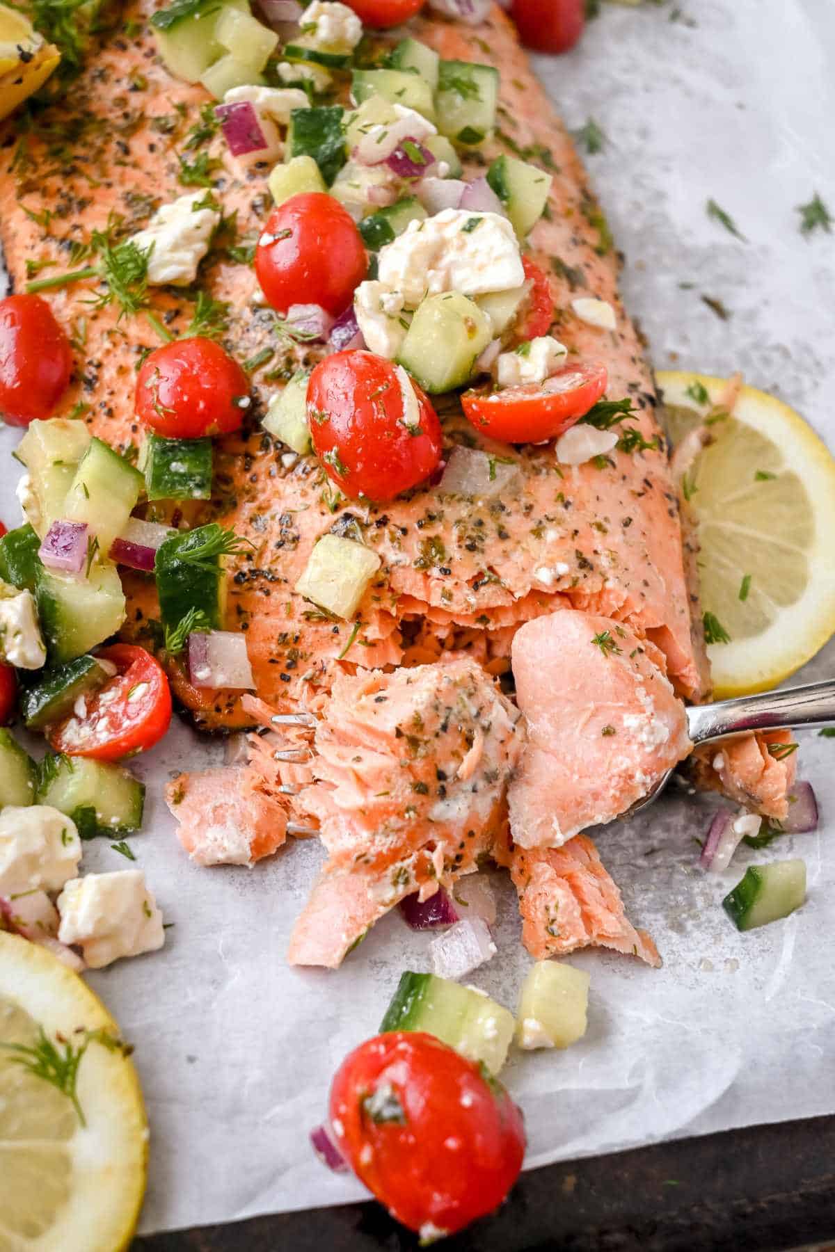 close up shot of greek salmon fillet on a fork.