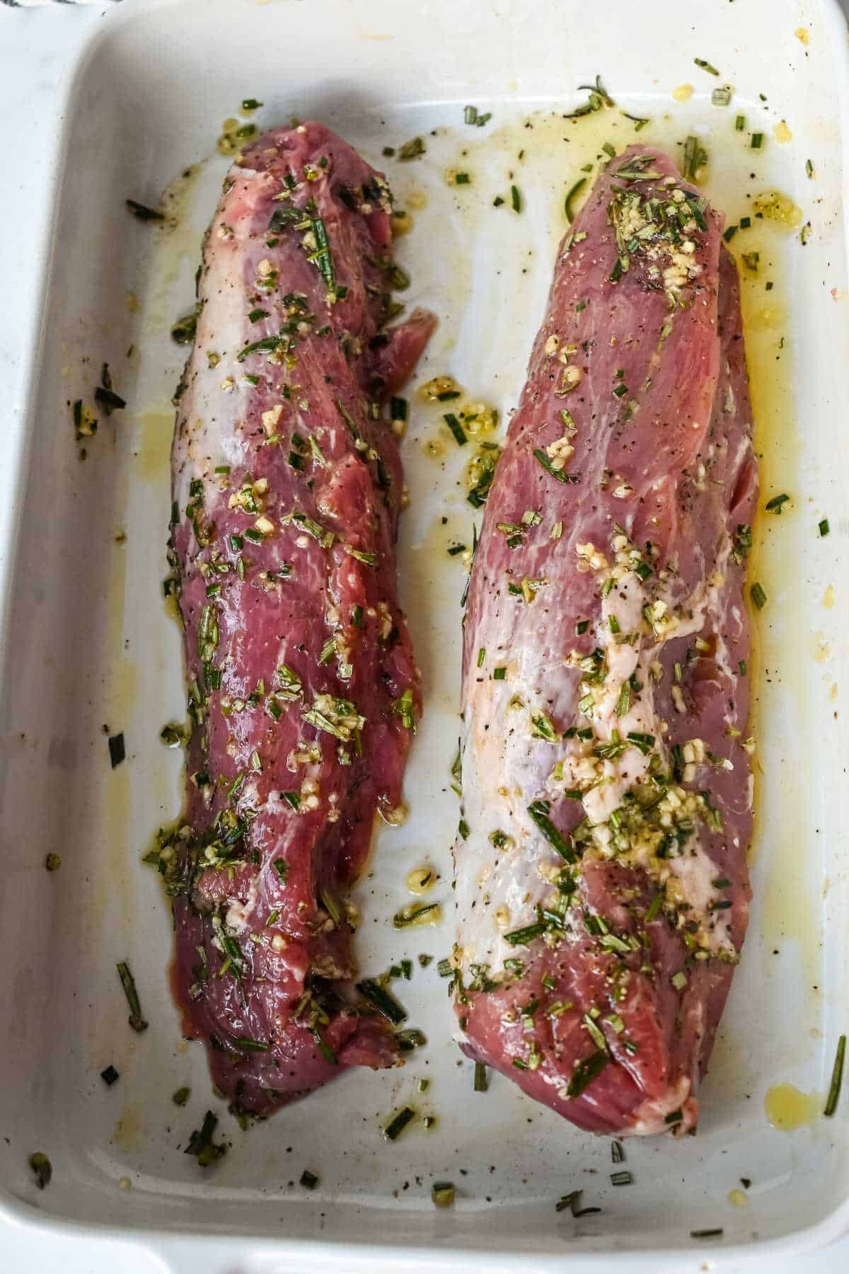 raw pork marinating in a pan.
