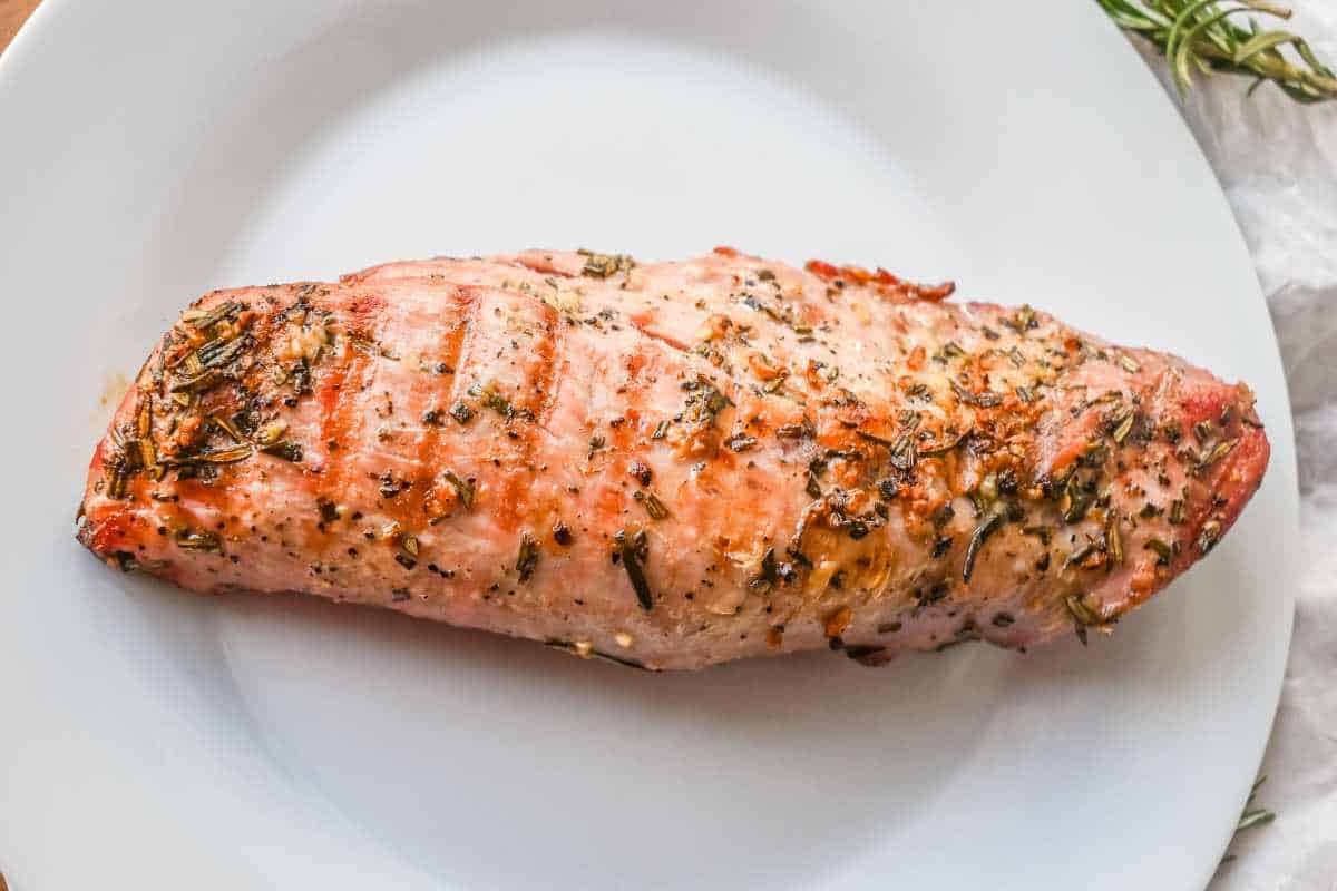 resting pork on a white plate.