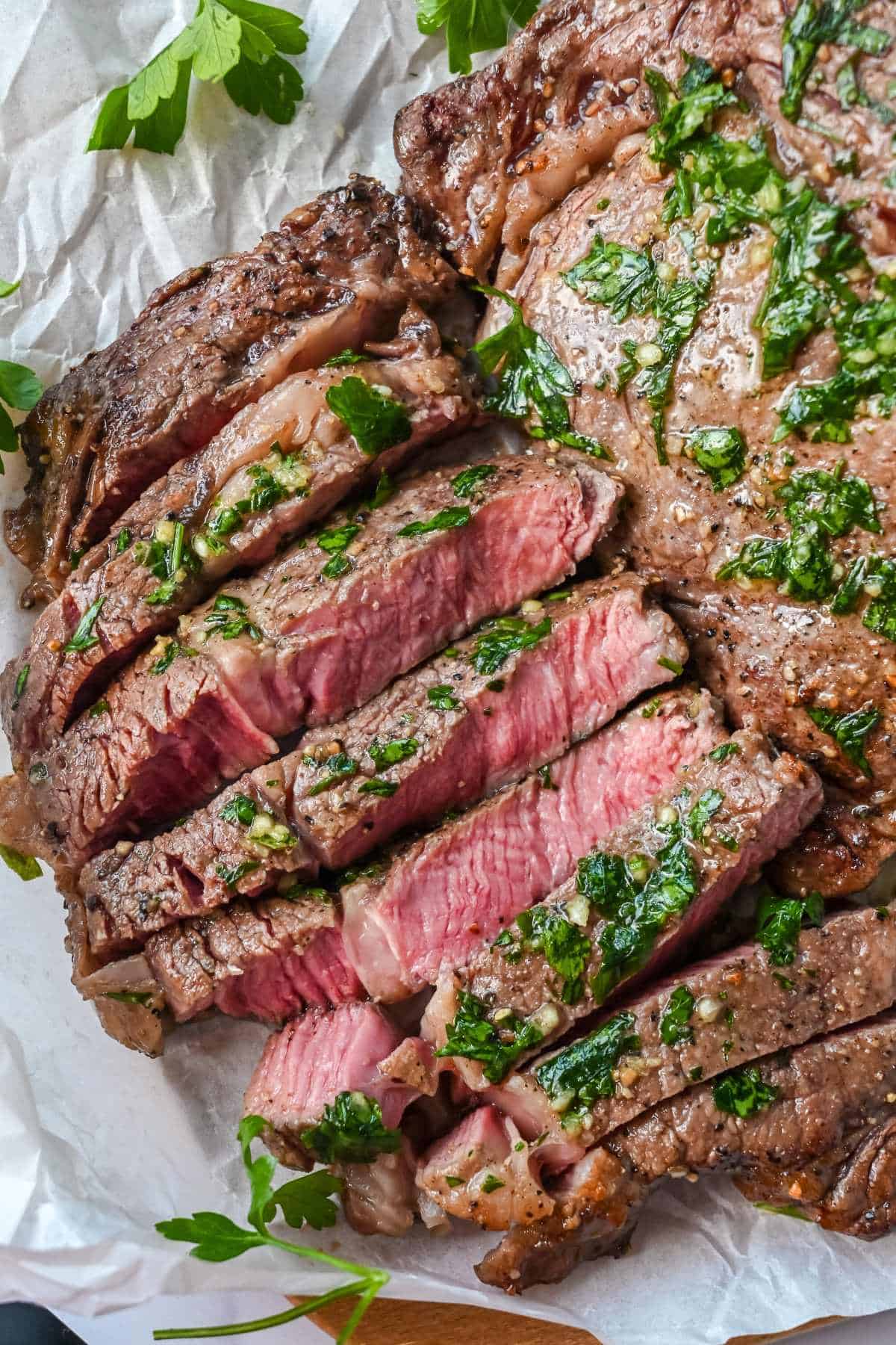 sliced air fryer ribeye with garlic her butter.