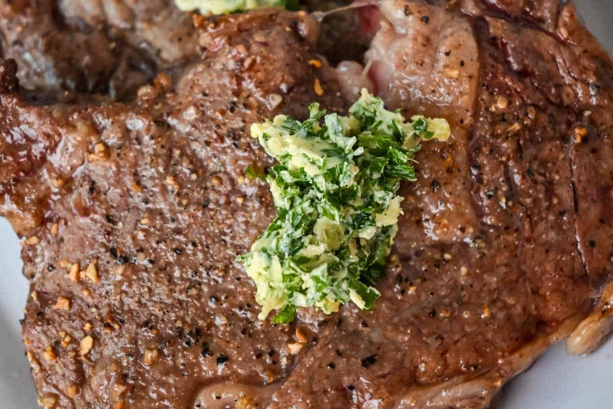 air fryer ribeye topped with compound butter.