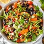 close up shot of spring mix salad with assorted salad toppings.