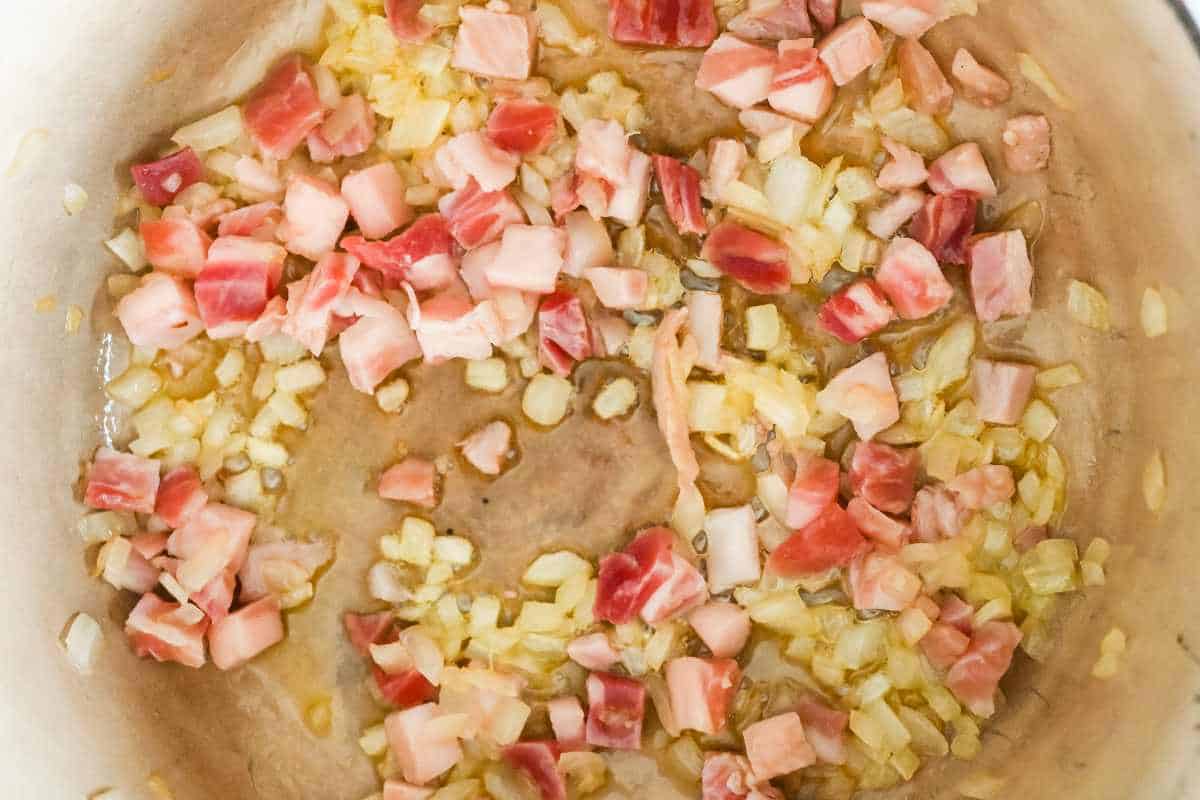 pancetta and onions cooking in a pan.