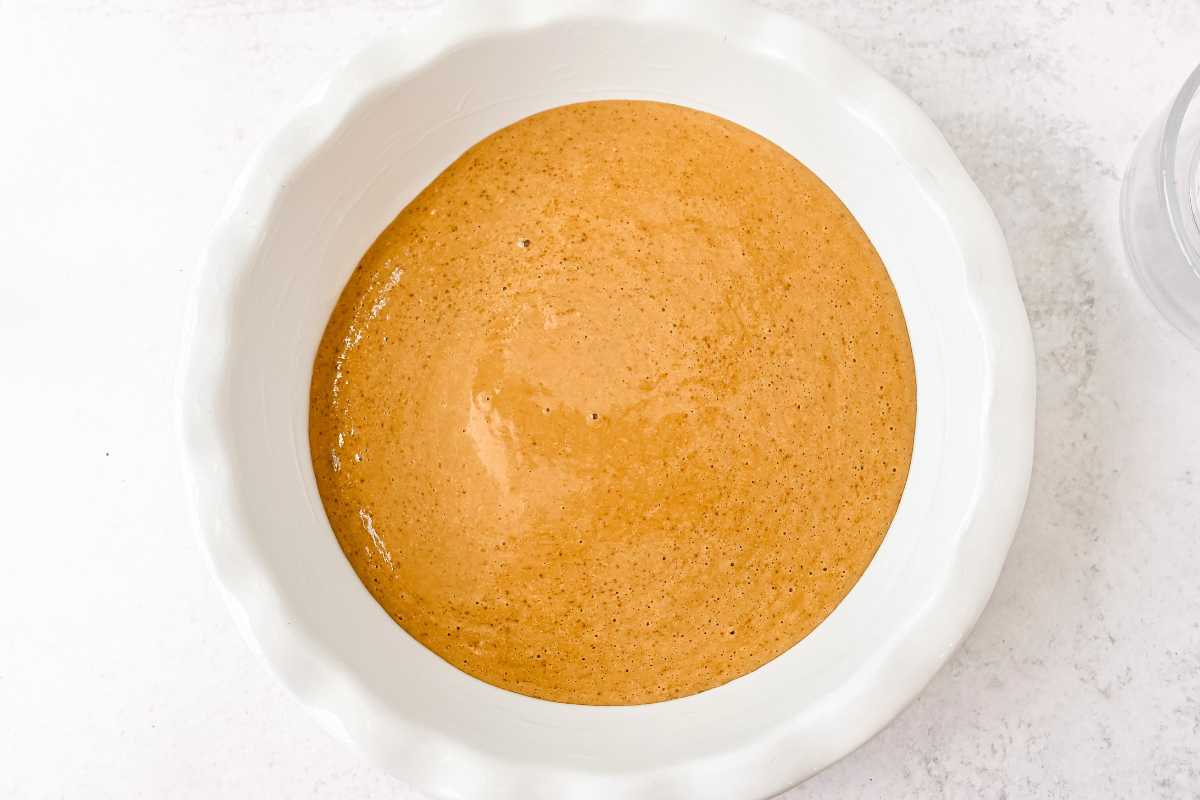 batter in a white pie plate on a white background.