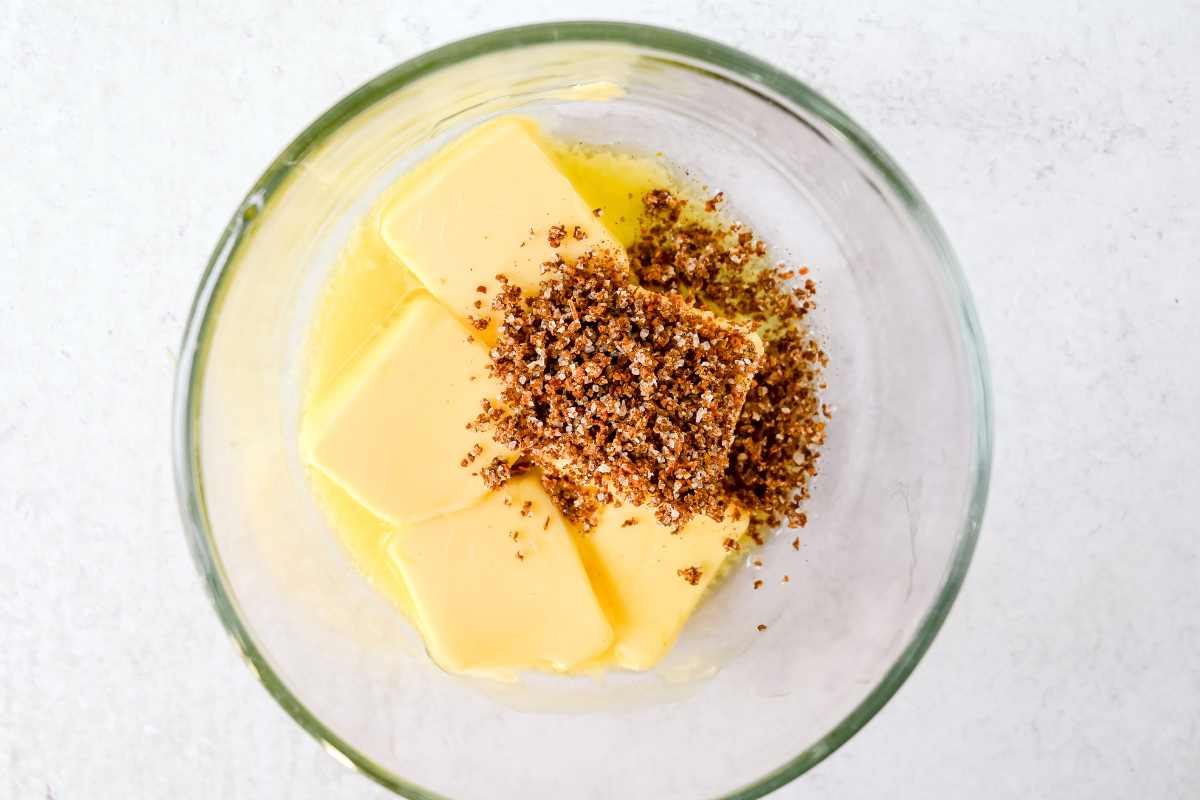butter and chili lime seasoning in a glass bowl.