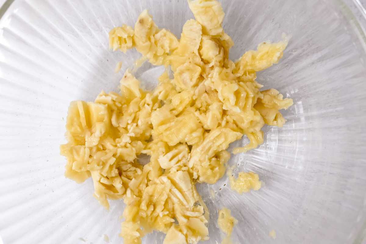mashed banana in a glass bowl.