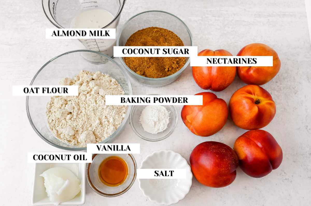 labeled ingredients for nectarine cobbler on a light gray background.
