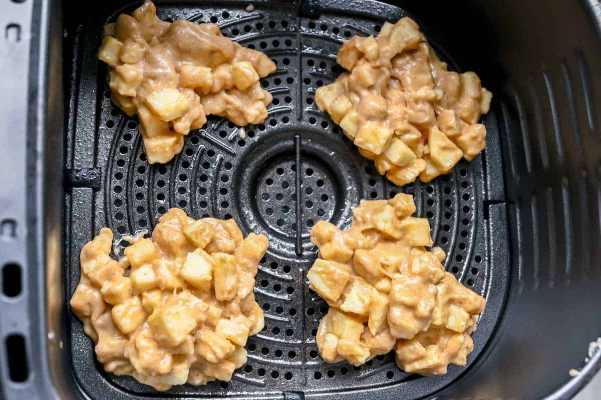 apple fritters in air fryer basket.