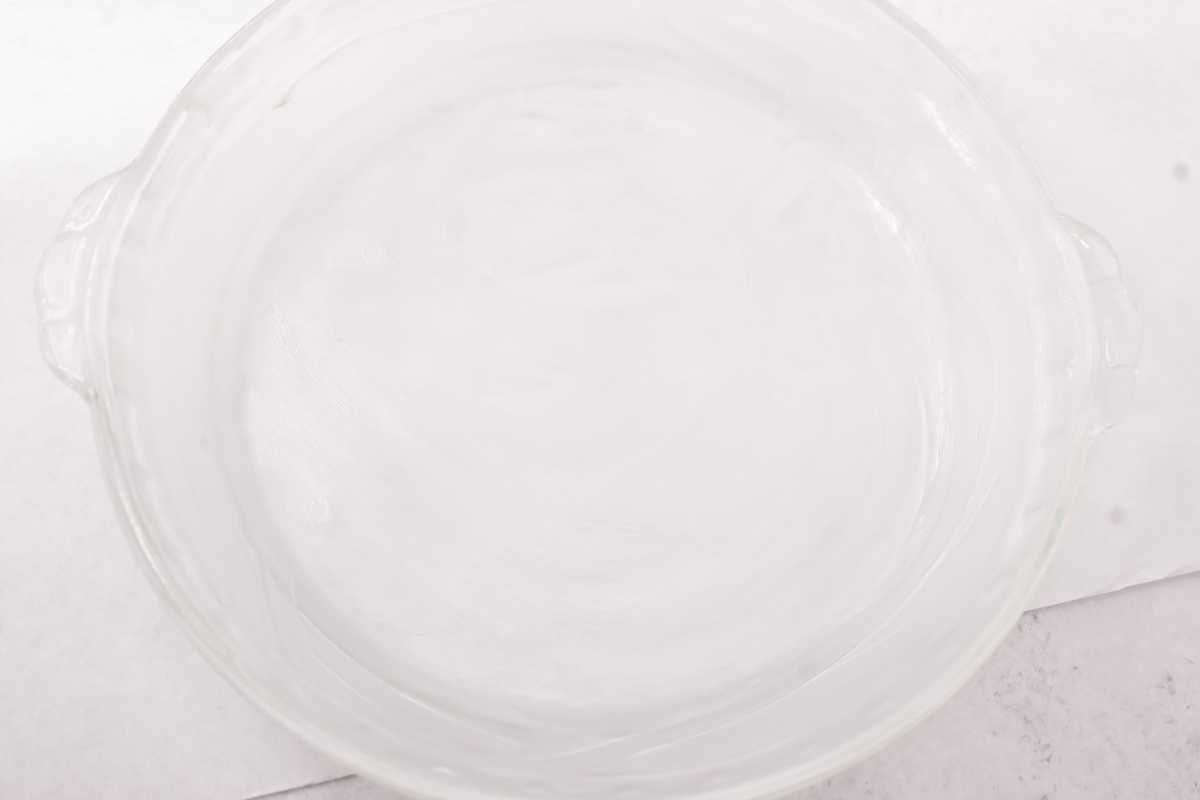 prepared glass pie dish on a light gray background.