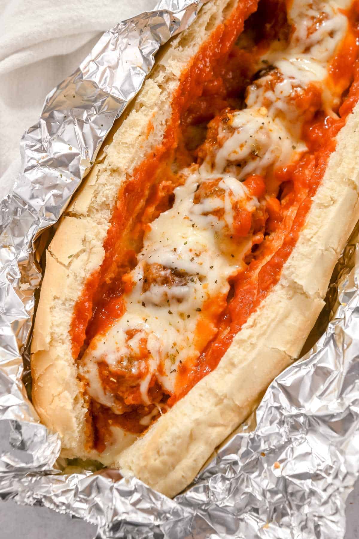 baked turkey meatball sub open on top of foil.