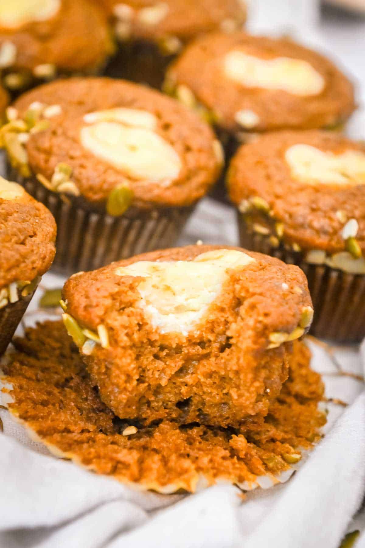 close up bite shot of starbucks pumpkin muffins with cream cheese filling.