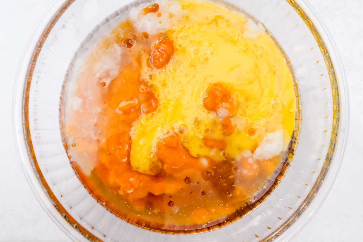 wet ingredients in a glass bowl on a light gray background.