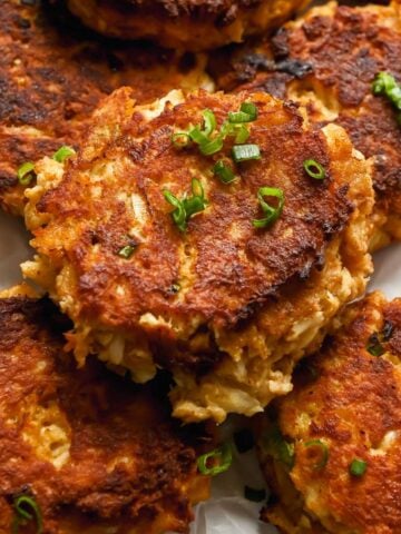 close up of Maryland-style crab cakes topped with green onions.