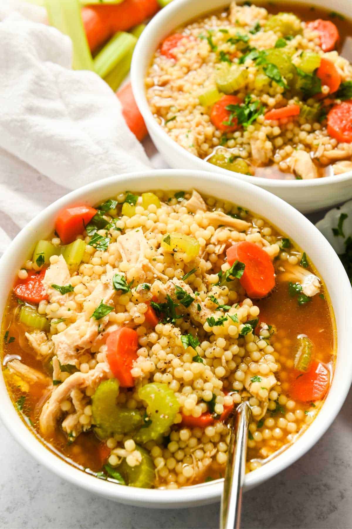 two bowls of chicken pastina soup.