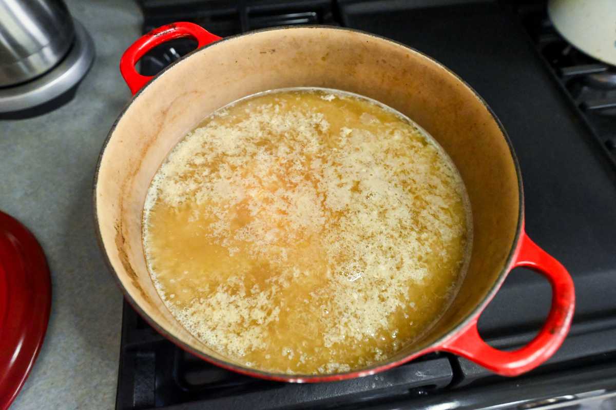 broth boiling in a red pot.