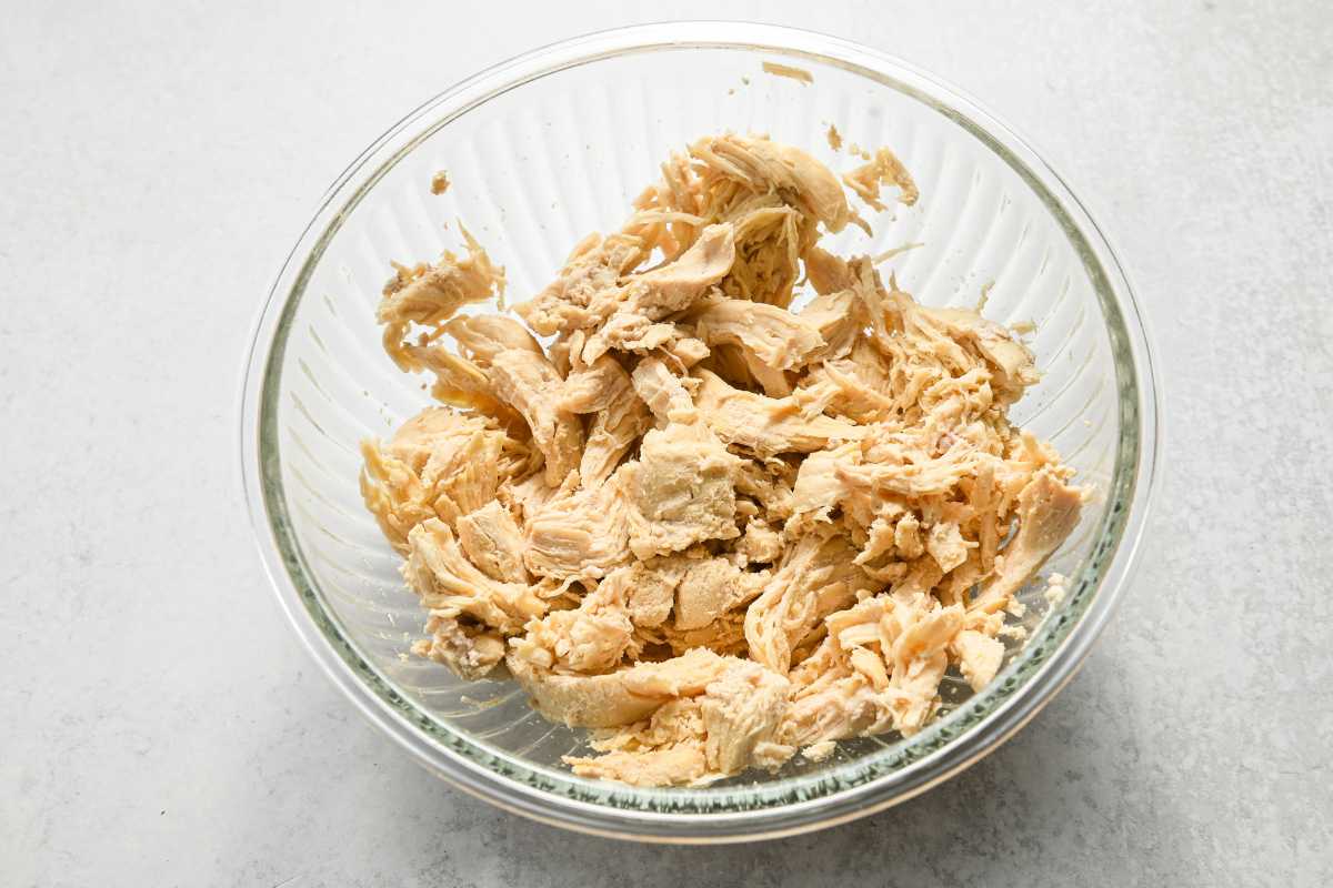 cooked shredded chicken in a glass bowl