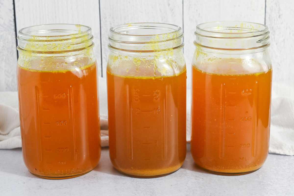 3 glass jars filled with homemade chicken bone broth.