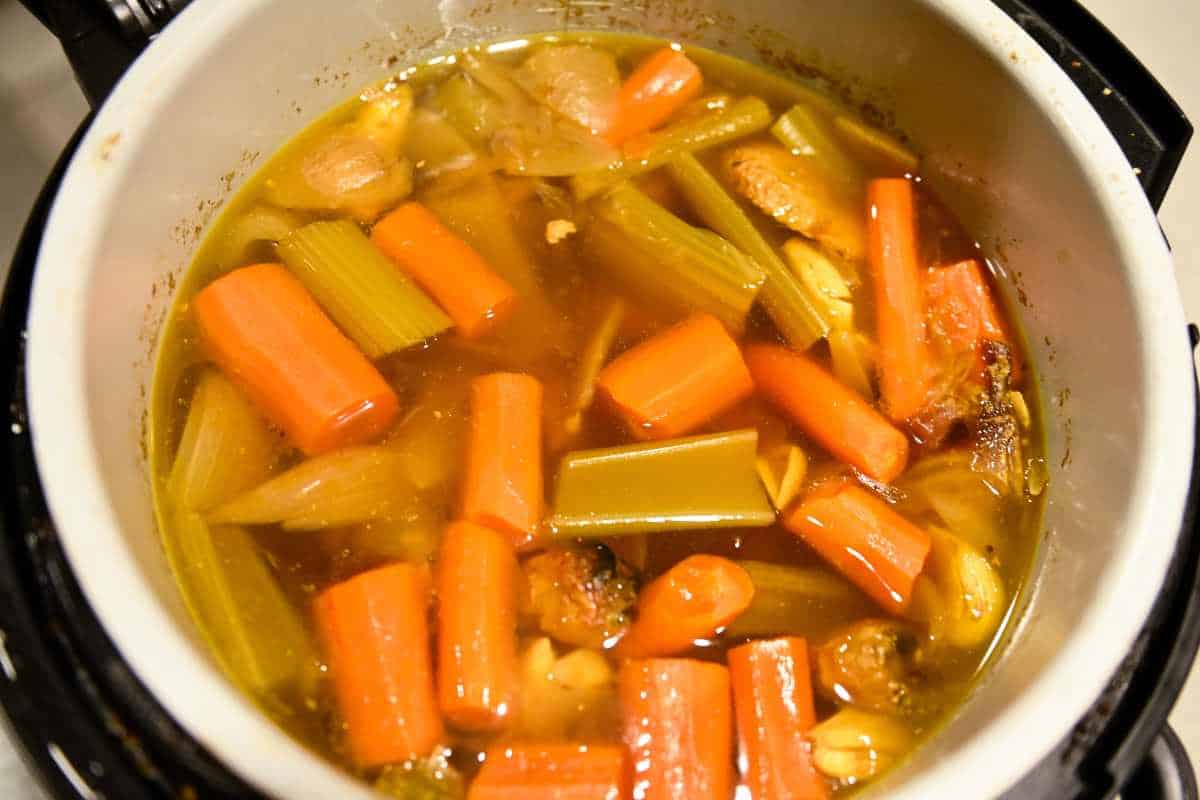 cooked vegetables in broth in an Instant Pot.