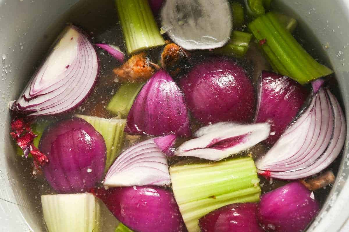 vegetables covered in water in a pot.
