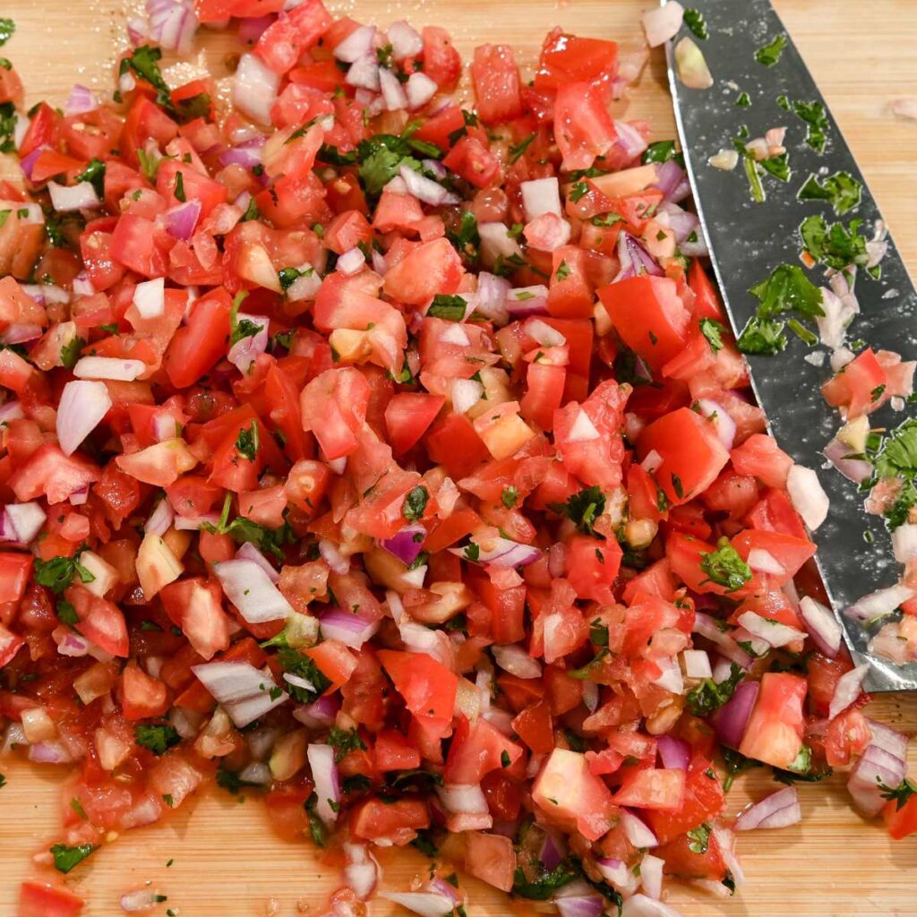 chopped mild pico de gallo ingredients on a cutting board.