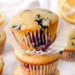 close up shot of blueberry lemon muffin with liner unwrapped.