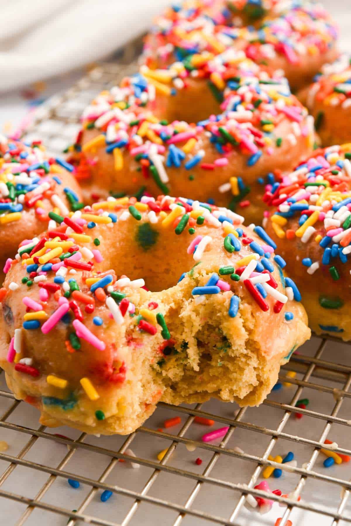 close up bite shot of funfetti donuts.