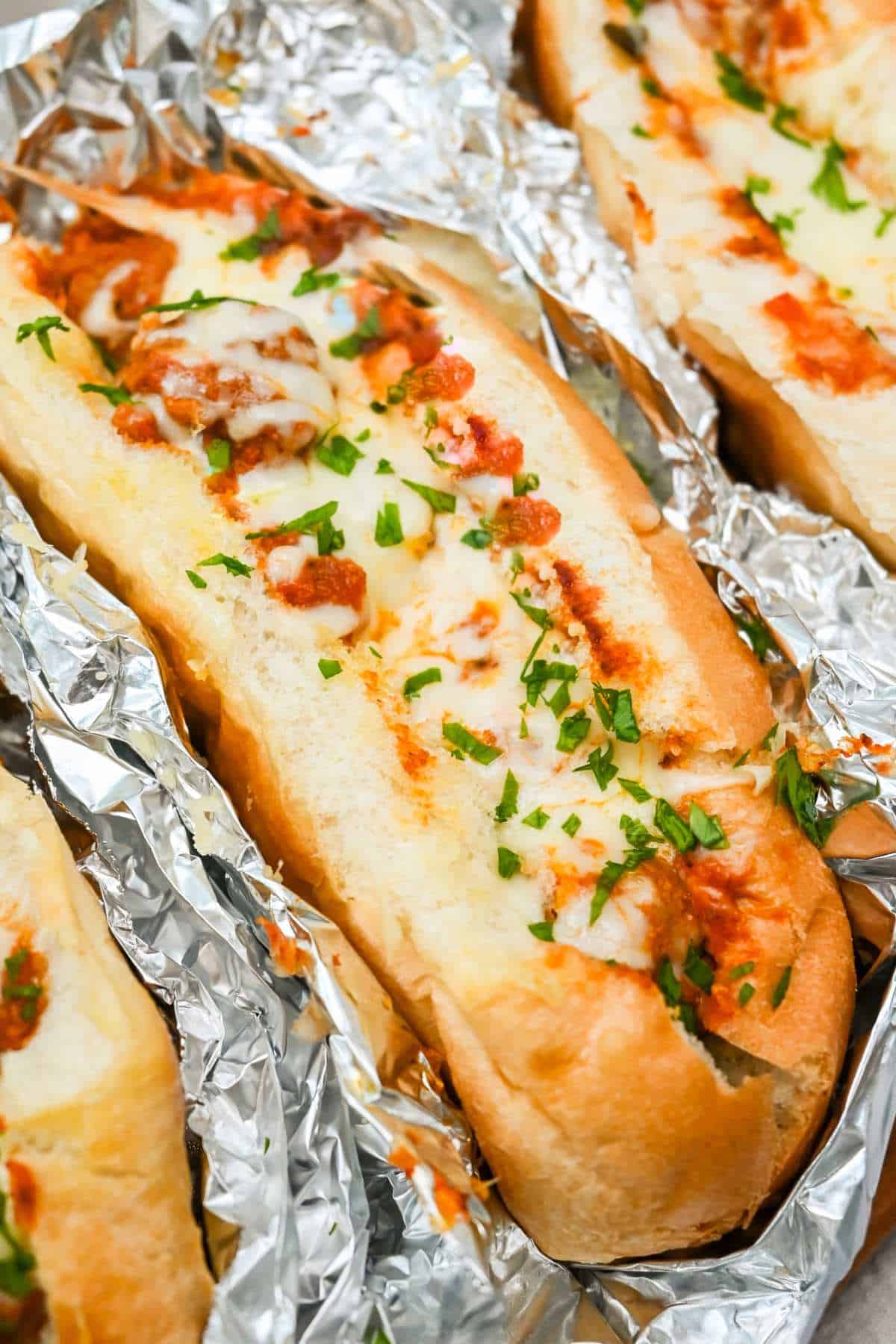 long view close up of a turkey baked meatball sub topped with melted cheese.