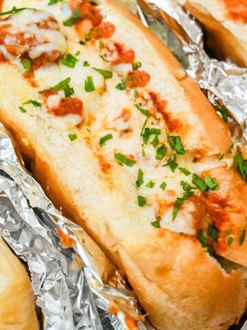 close up of a turkey baked meatball sub topped with melted cheese.