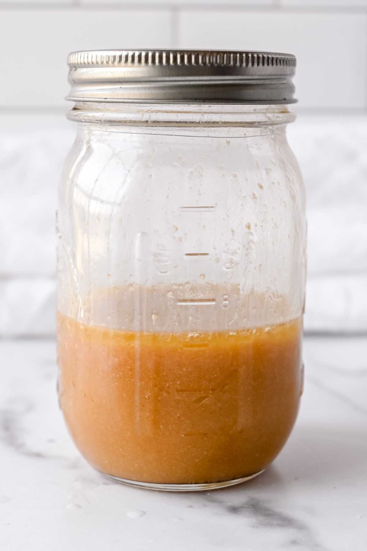 mason jar half full of vinaigrette.