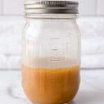 half filled jar of red wine vinaigrette.