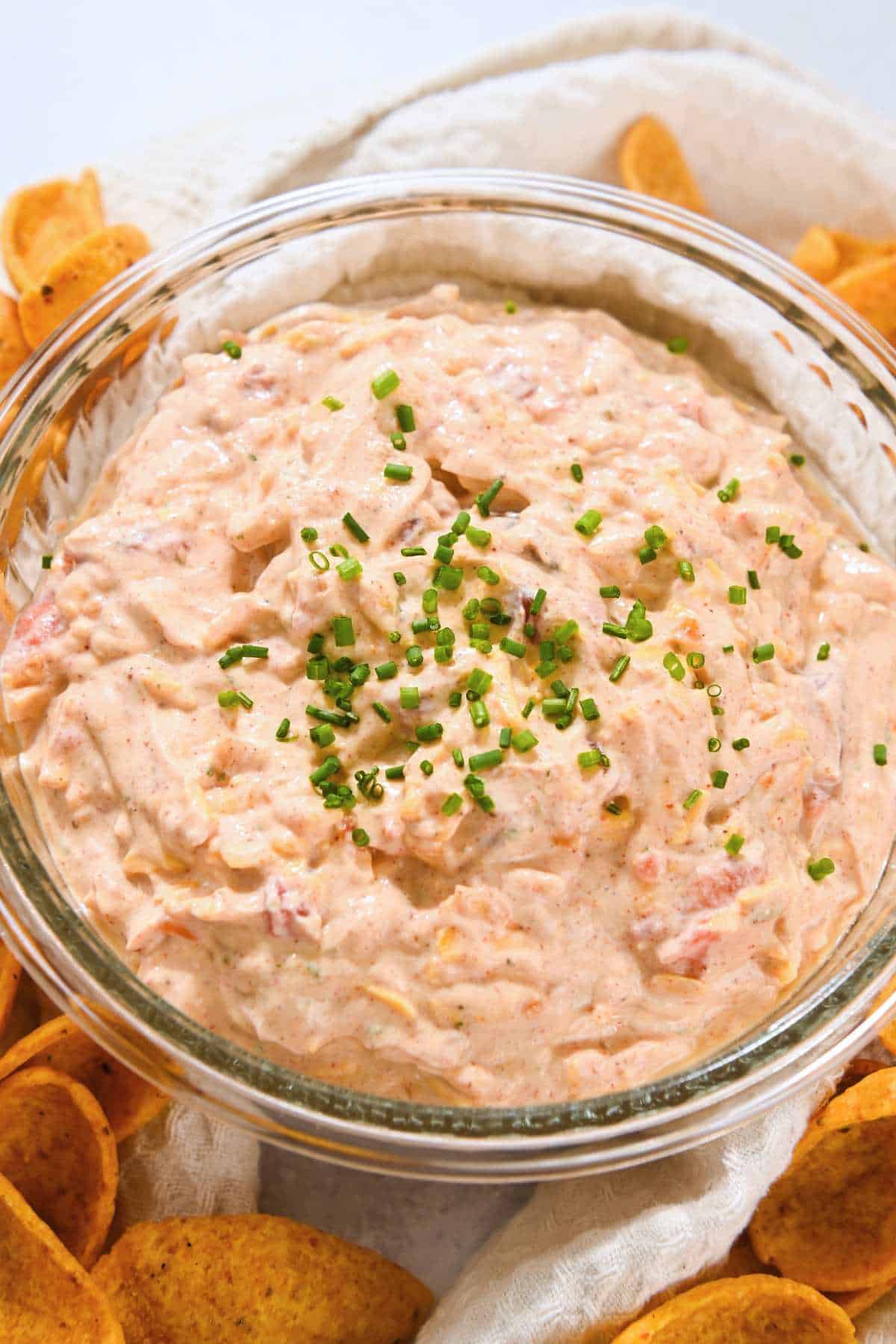 close up shot of pool dip in a glass bowl topped with chives.