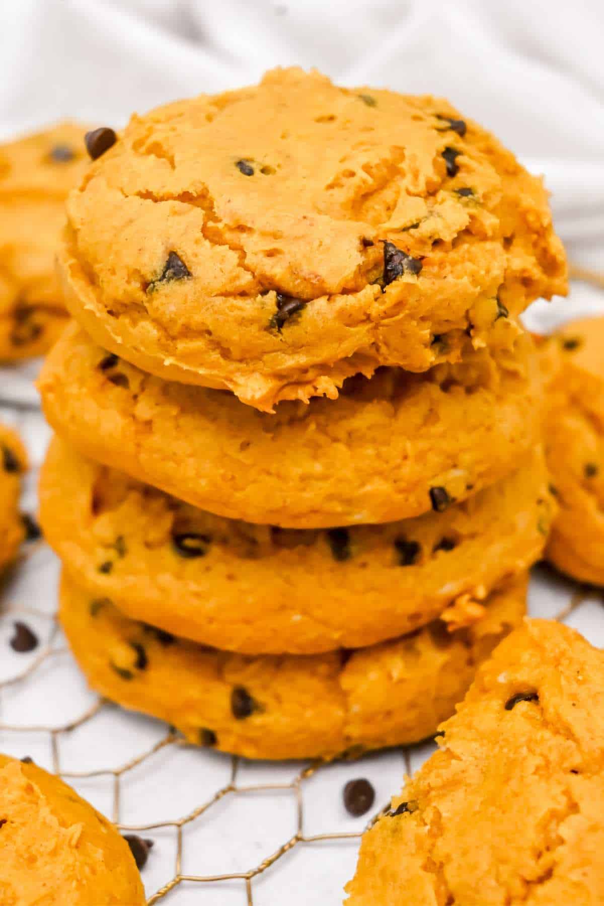 stack of four cake mix pumpkin cookies with chocolate chips.