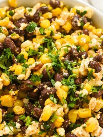 square photo of closeup shot of corn, black bean, and feta dip.