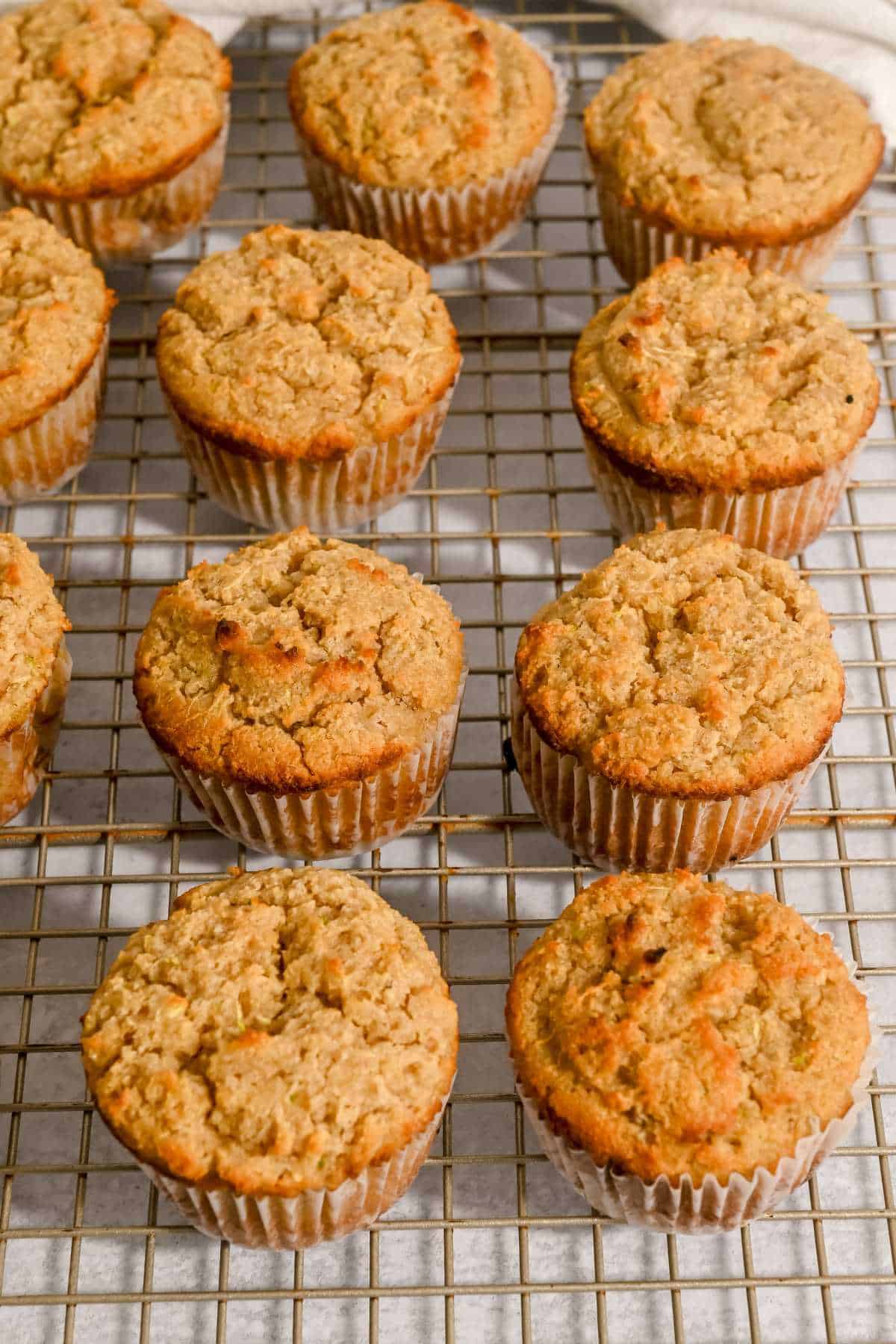 9 almond flour zucchini muffins on a cooling rack.