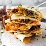 four beef steak quesadillas in a stack.