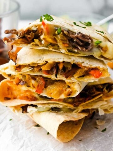 four beef steak quesadillas in a stack.
