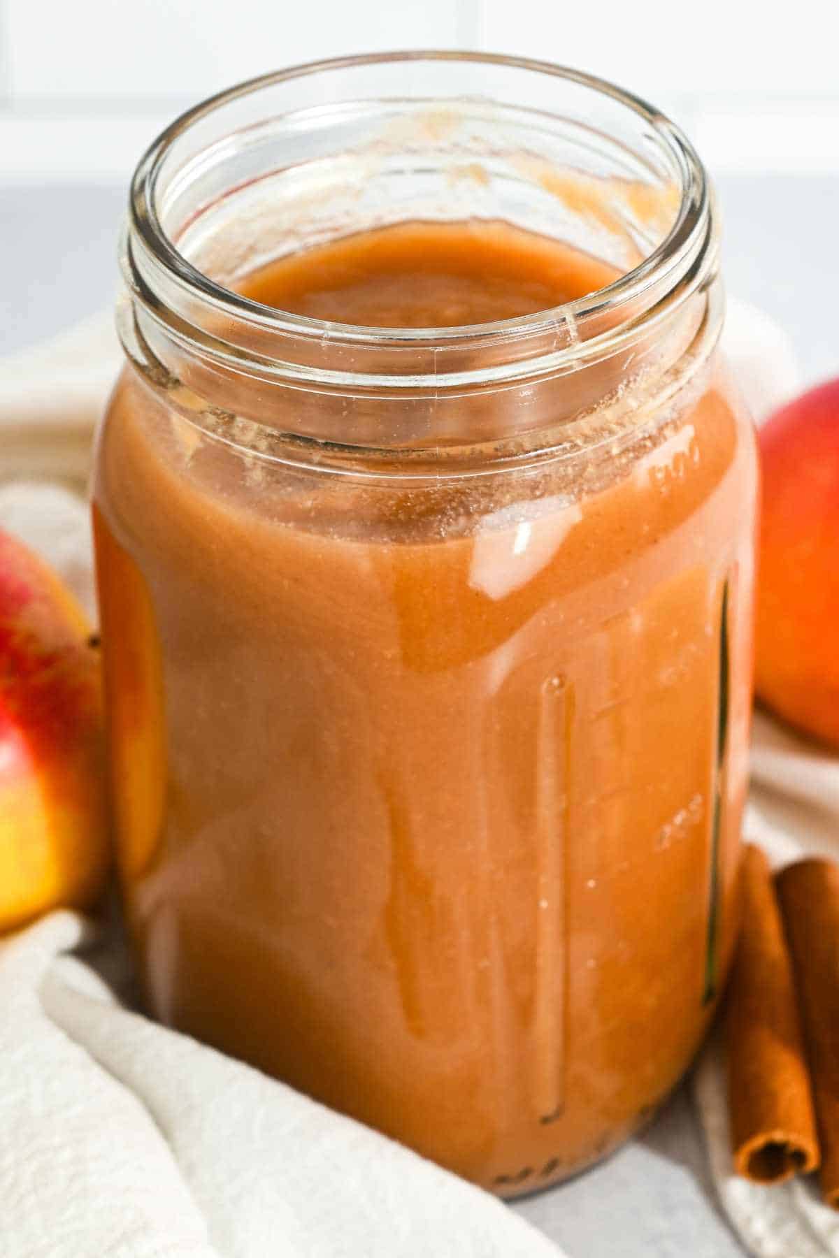 glass jar filled with homemade crockpot applesauce.