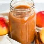 cropped image showing homemade crockpot applesauce in a jar.