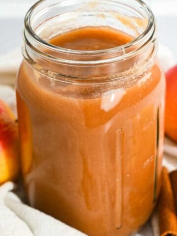 cropped image showing homemade crockpot applesauce in a jar.