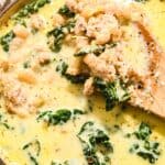 close up of creamy kale soup with beans and sausage.