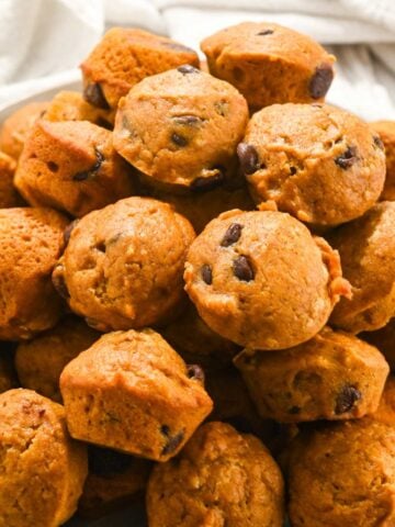 close up shot of pumpkin mini muffins in a pile.