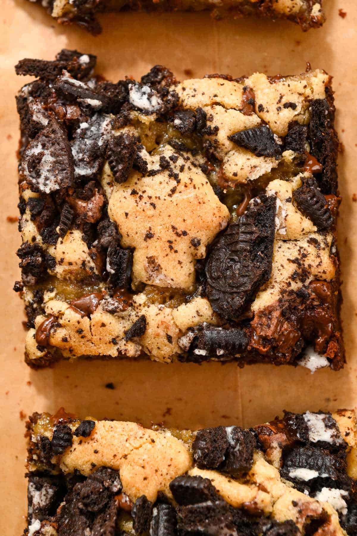 close up of oreo brookie bar on brown parchment paper.