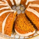 close up of a slice of pumpkin applesauce cake topped with cream cheese frosting glaze.